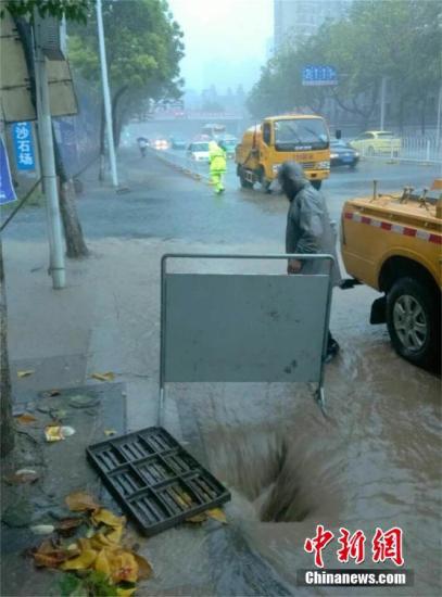 湖北省气象灾害应急指挥部在19日9时启动气象灾害暴雨Ⅳ级应急响应，湖北省气象局随即进入响应状态，并启动重大气象灾害暴雨Ⅳ级应急响应，要求各单位严格按照《湖北省气象局气象灾害应急响应工作流程》做好各项工作。图为武汉鹦鹉大道朝阳路口段，水务工人揭盖排水。 钟欣 摄 视频：武汉迎入梅首场暴雨 局部降雨量超30年一遇 来源:中国新闻网