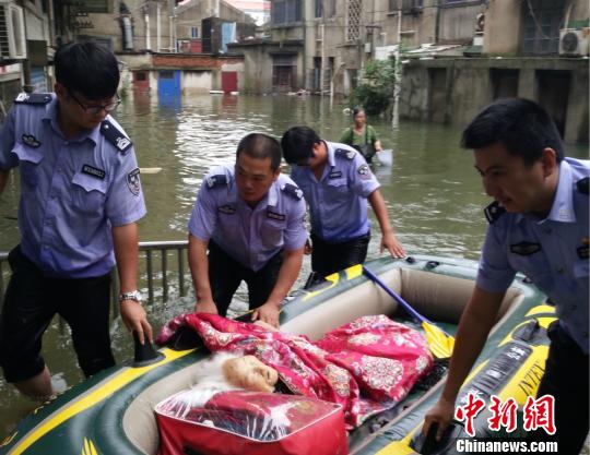 图为民警余明等人用皮划艇救出106岁高龄的老人。蒋寒 摄